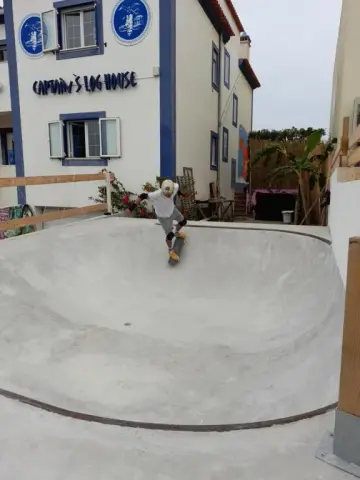 Skater dropping into the on-site concrete bowl